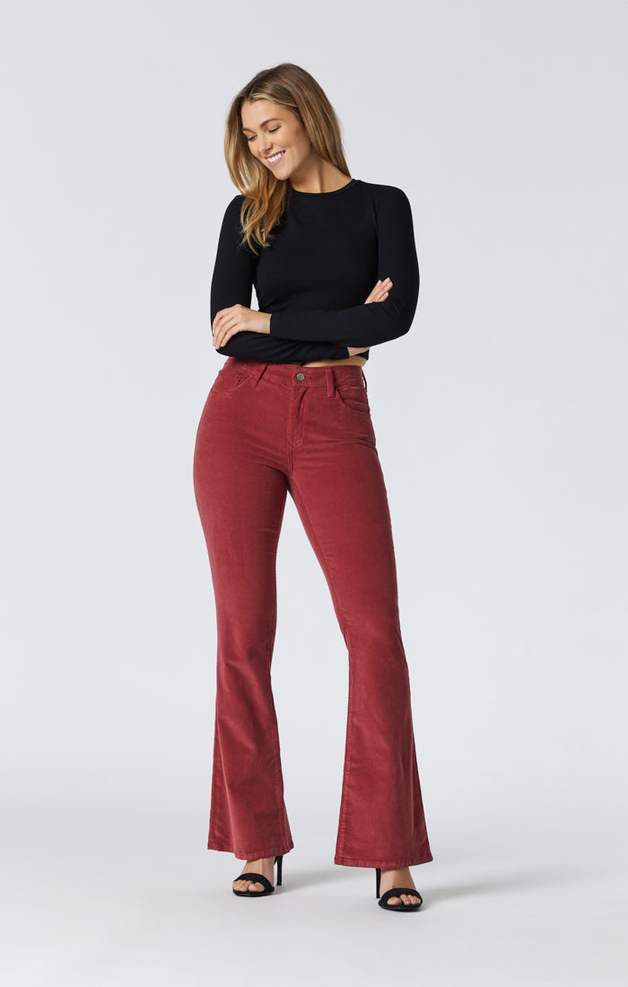 woman wearing red corduroy pants