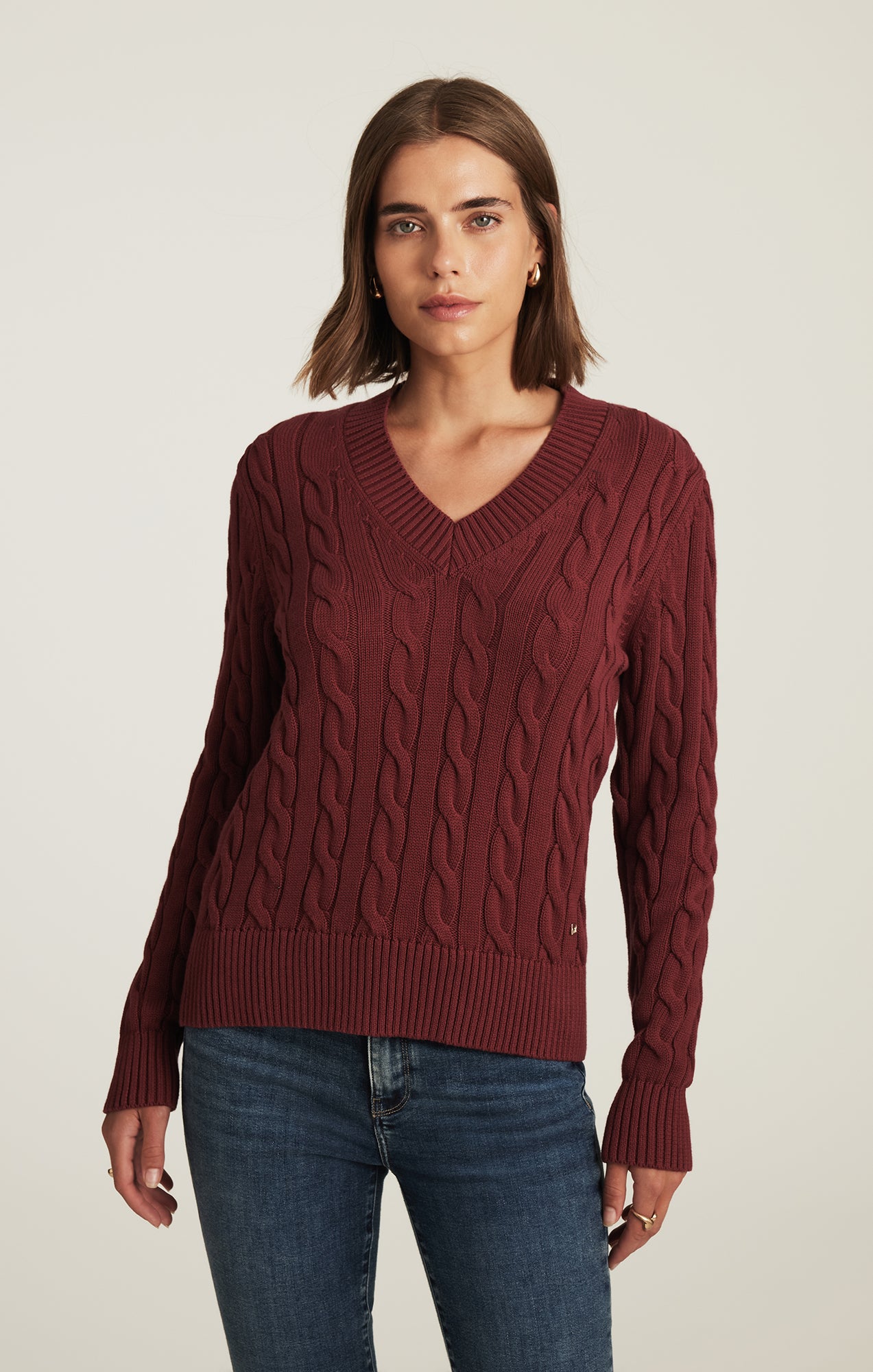 CABLE-KNIT V-NECK SWEATER IN POMEGRANATE