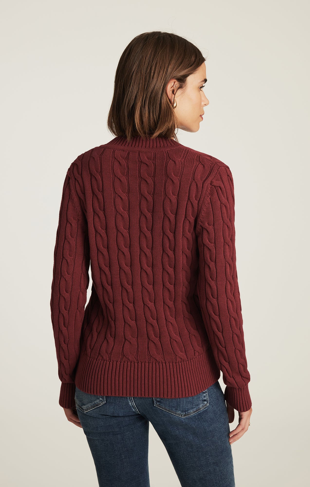CABLE-KNIT V-NECK SWEATER IN POMEGRANATE